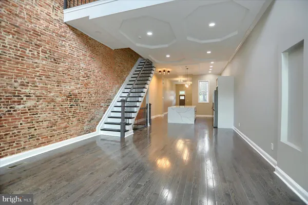 a large kitchen with kitchen island white cabinets and stainless steel appliances