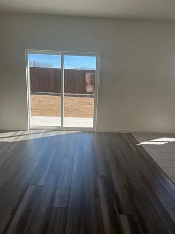 a view of wooden floor and windows in a room