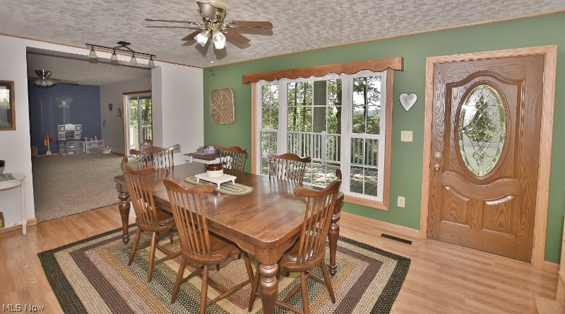 5007 Raven Road Southeast Carrollton, OH 44615 - Photo 13 of 50 The dining area features a beautiful windows and an entry door leading to the front deck.