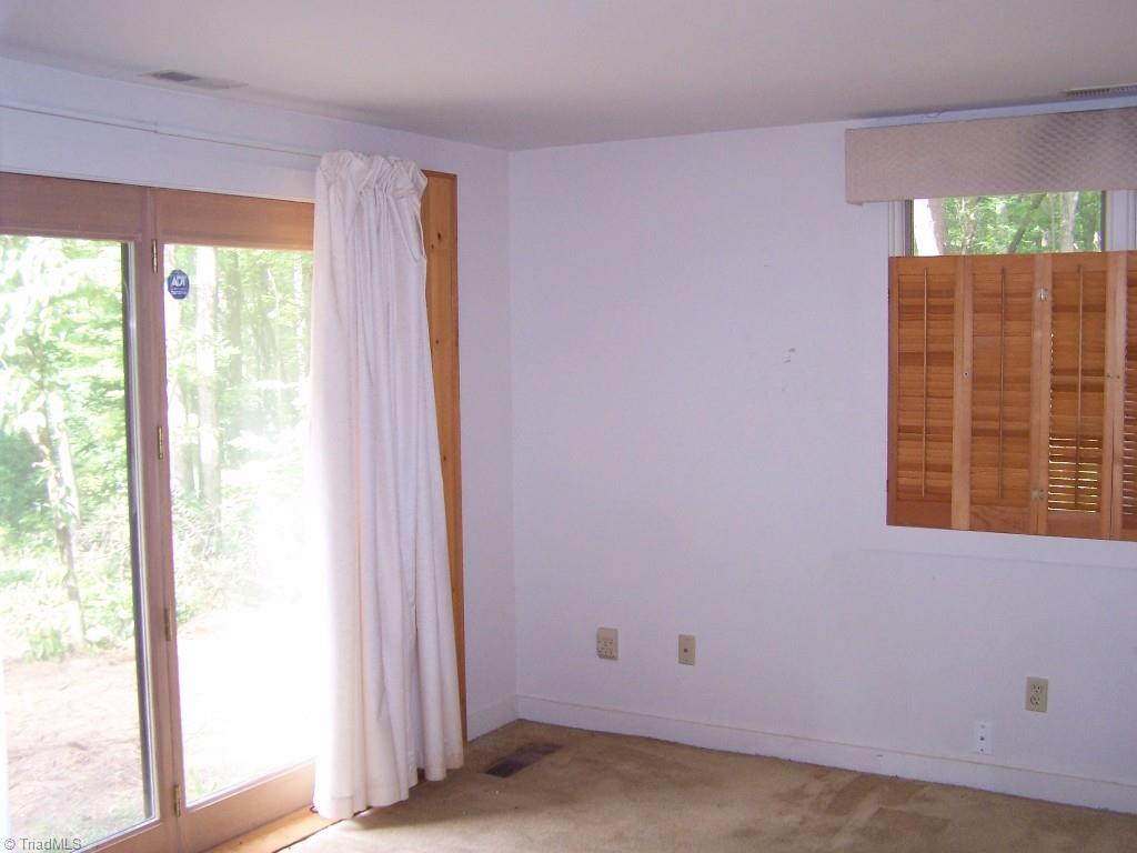 1310 Pebblebrook Road Winston-Salem, NC 27105 - Photo 16 of 25 Second bedroom with sliding glass door to backyard