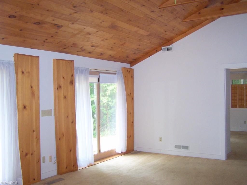 Living room with vaulted ceilings and beautiful wood details.