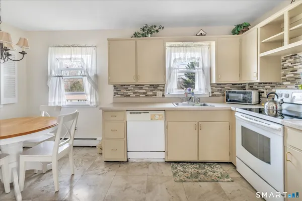 a kitchen with a white refrigerator stove and sink