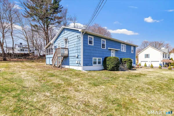 a view of a house with a yard and garage