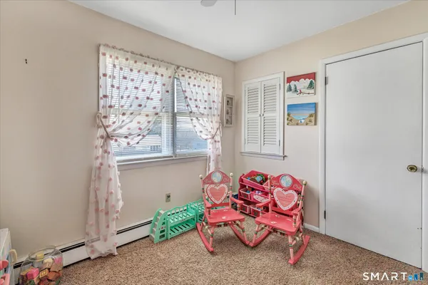 a room with furniture a flat screen tv and a window