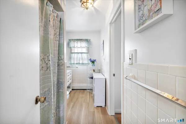 a bathroom with a sink toilet and window