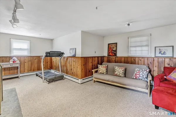 a view of a bedroom with furniture and windows