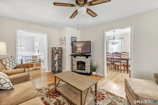 a living room with furniture a rug and a window