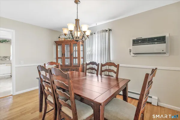 a dining room with furniture and chandelier