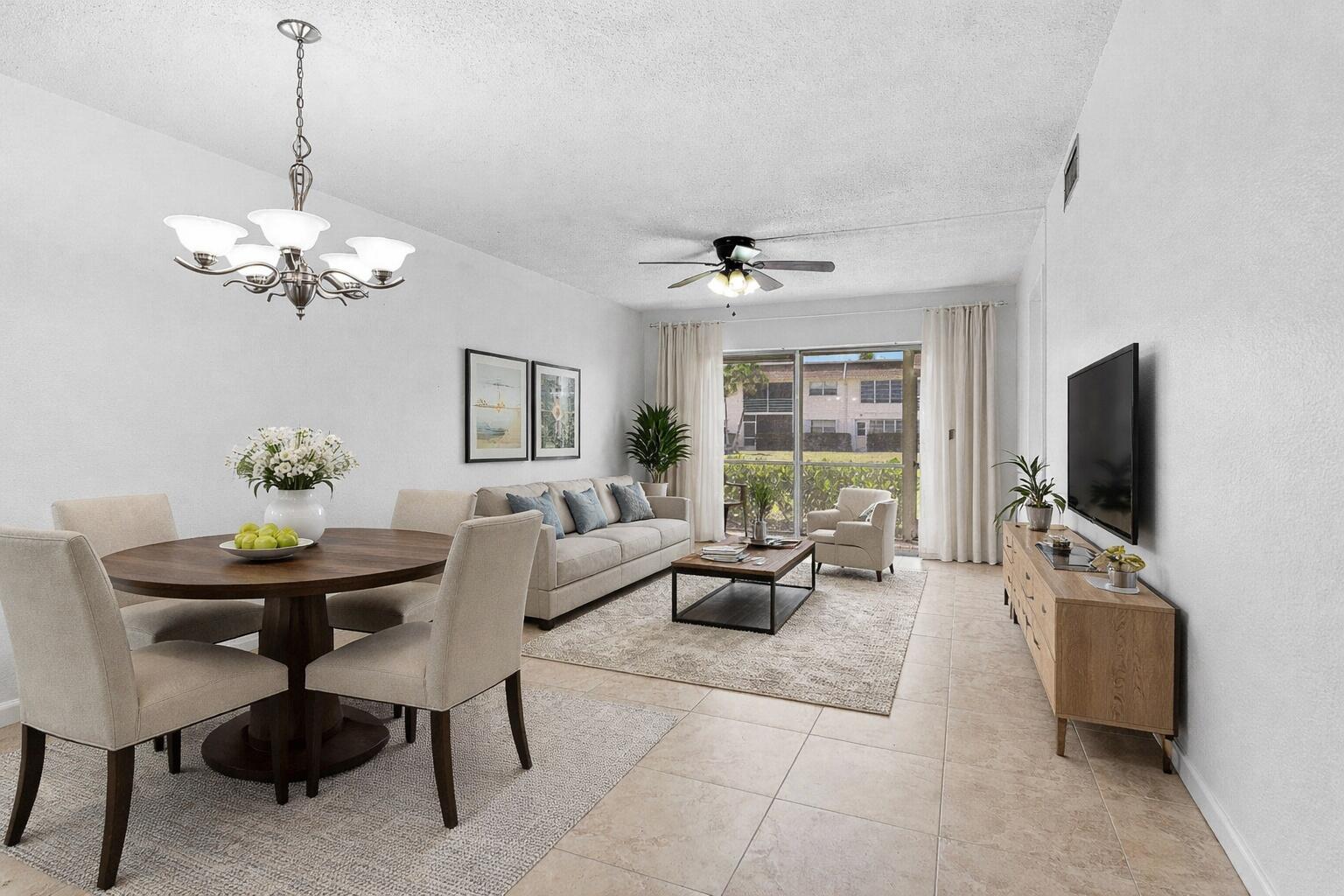 a living room with furniture a chandelier and a flat screen tv