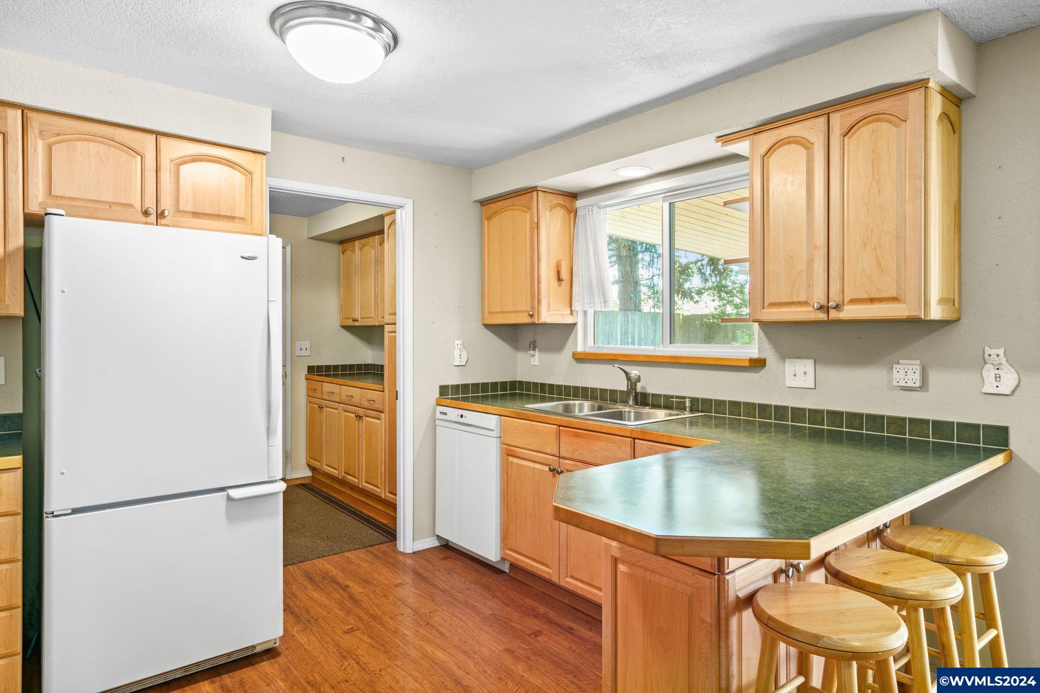 2254 8th Street Springfield, OR 97477 - Photo 9 of 34 a kitchen with a refrigerator a stove a sink and a cabinets