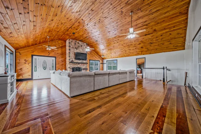 a view of a roof deck with table and chairs with wooden floor and fence