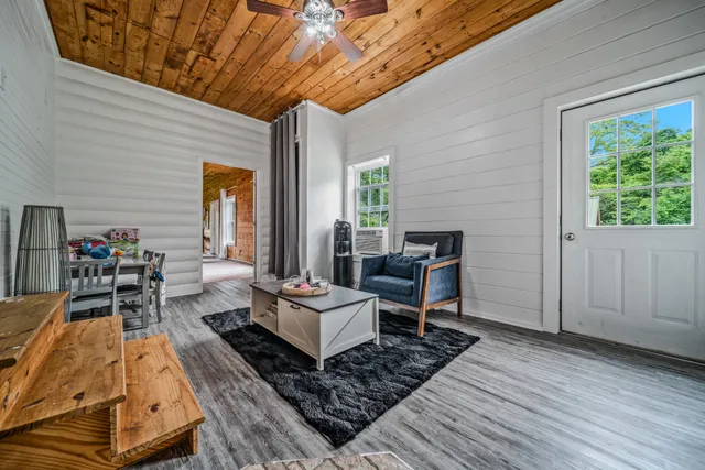 a spacious bedroom with a bed and a flat screen tv