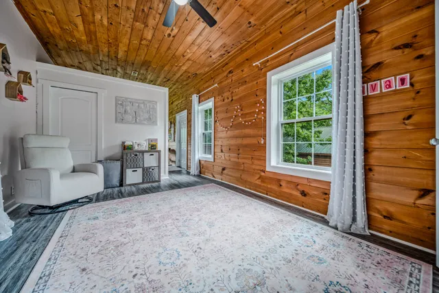 a bedroom with furniture and a wooden floor