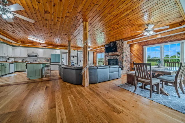 a view of a chairs and table on the wooden deck