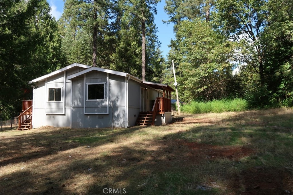 19138 New York Flat Road Forbestown, CA 95941 - Photo 12 of 37 a view of a house with backyard and trees