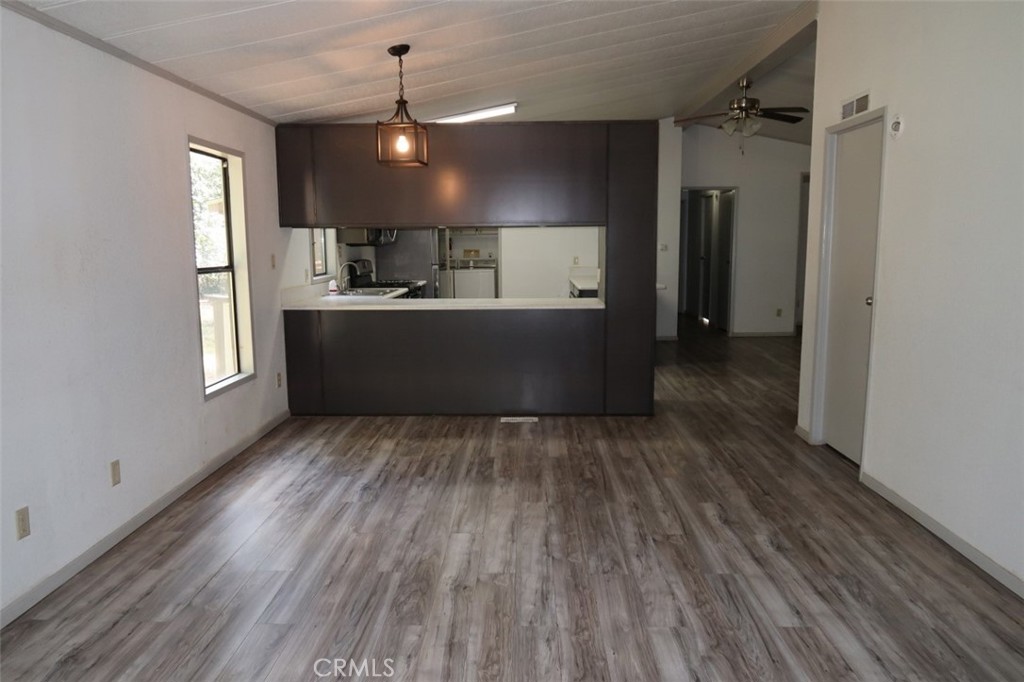 19138 New York Flat Road Forbestown, CA 95941 - Photo 18 of 37 a view of kitchen and empty room with wooden floor