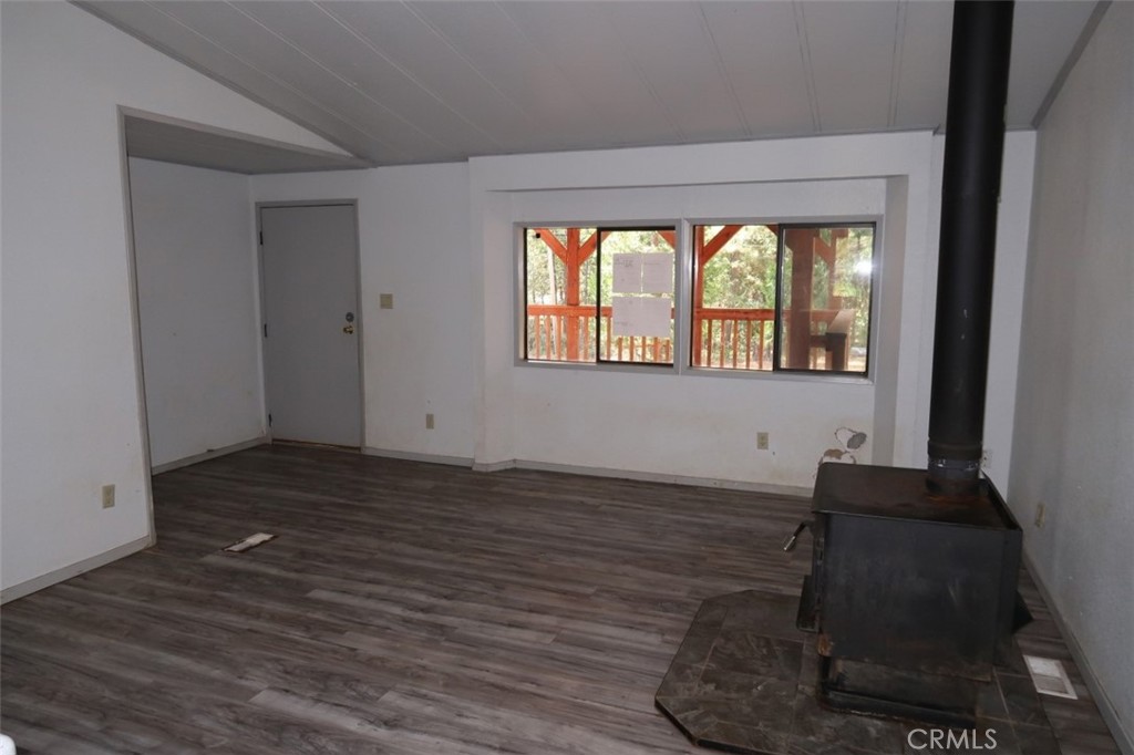 19138 New York Flat Road Forbestown, CA 95941 - Photo 21 of 37 a view of an empty room with wooden floor and a window