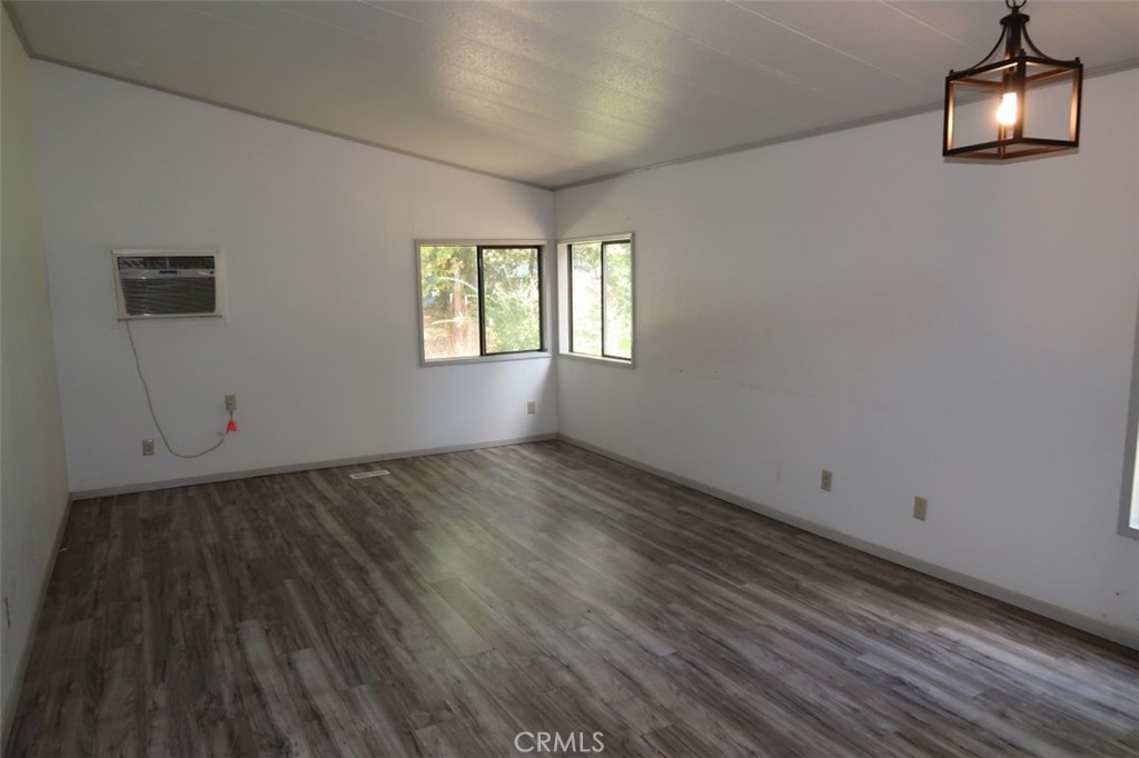 19138 New York Flat Road Forbestown, CA 95941 - Photo 22 of 37 an empty room with wooden floor and windows