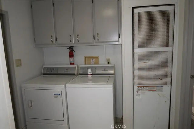 a view of an empty room with wooden floor and closet