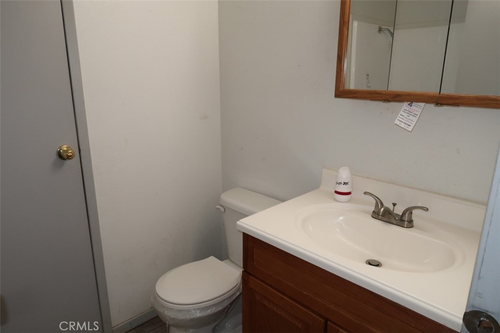 19138 New York Flat Road Forbestown, CA 95941 - Photo 29 of 37 a bathroom with a sink a toilet and mirror
