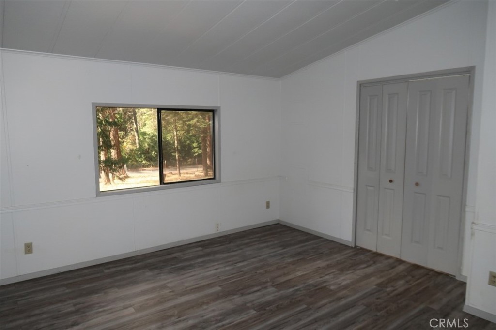 19138 New York Flat Road Forbestown, CA 95941 - Photo 3 of 37 a view of an empty room with wooden floor and a window
