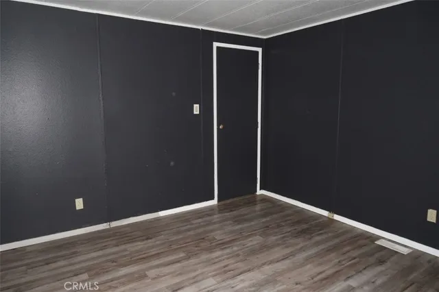 a view of dirt yard with large trees