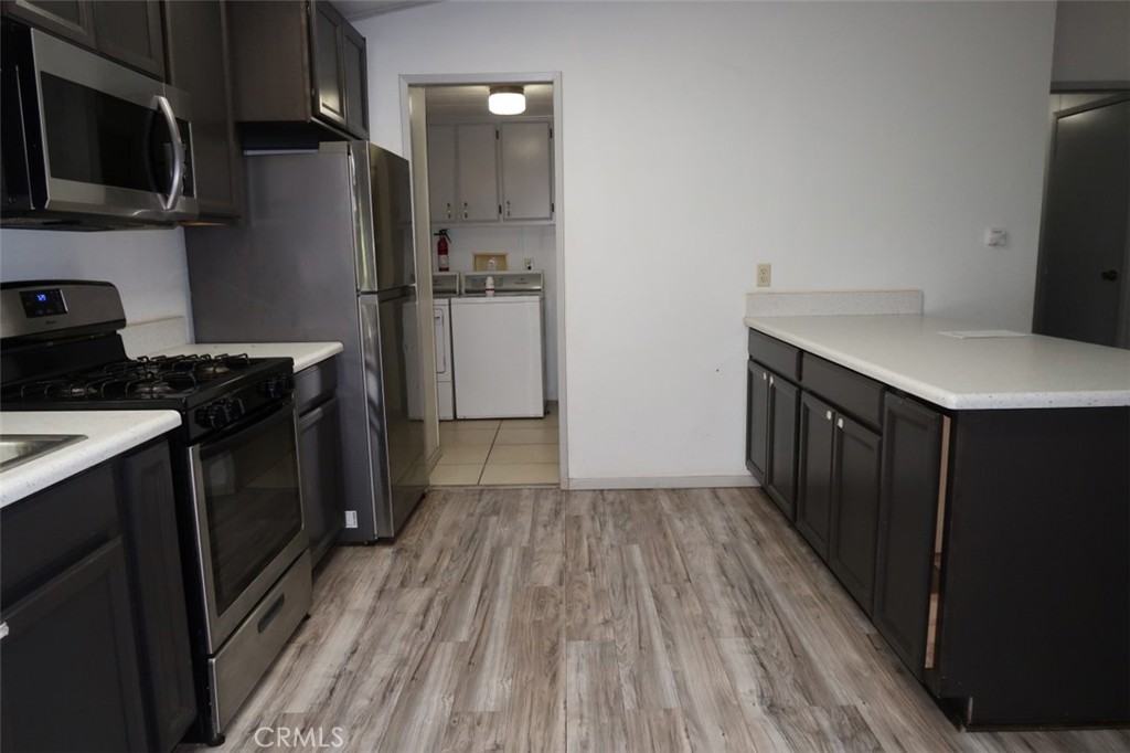 19138 New York Flat Road Forbestown, CA 95941 - Photo 5 of 37 a kitchen with a refrigerator stove and wooden cabinets