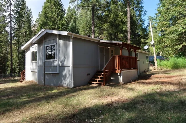 a view of backyard of house and car parked