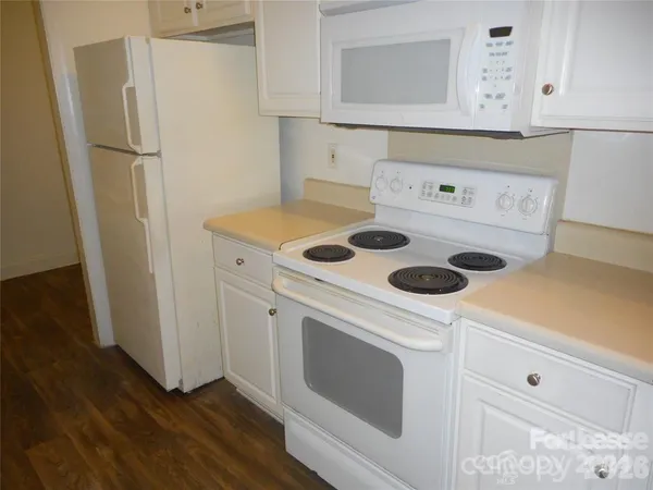 a kitchen with a stove and a refrigerator