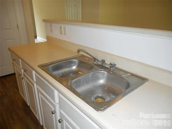 a kitchen with a sink and a stove top oven