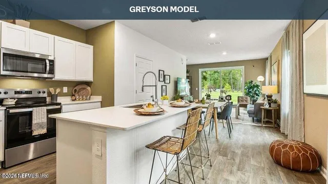 a kitchen with a sink appliances and a large window