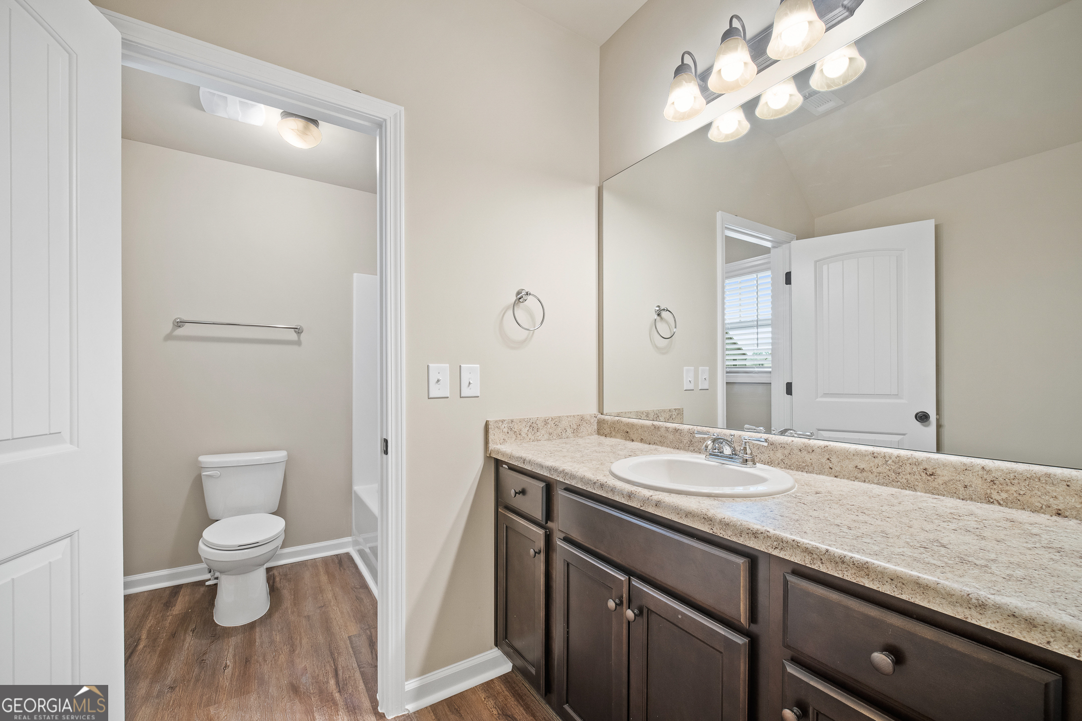 2275 Lovejoy Road Hampton, GA 30228 - Photo 13 of 20 a bathroom with a granite countertop toilet a sink and a mirror