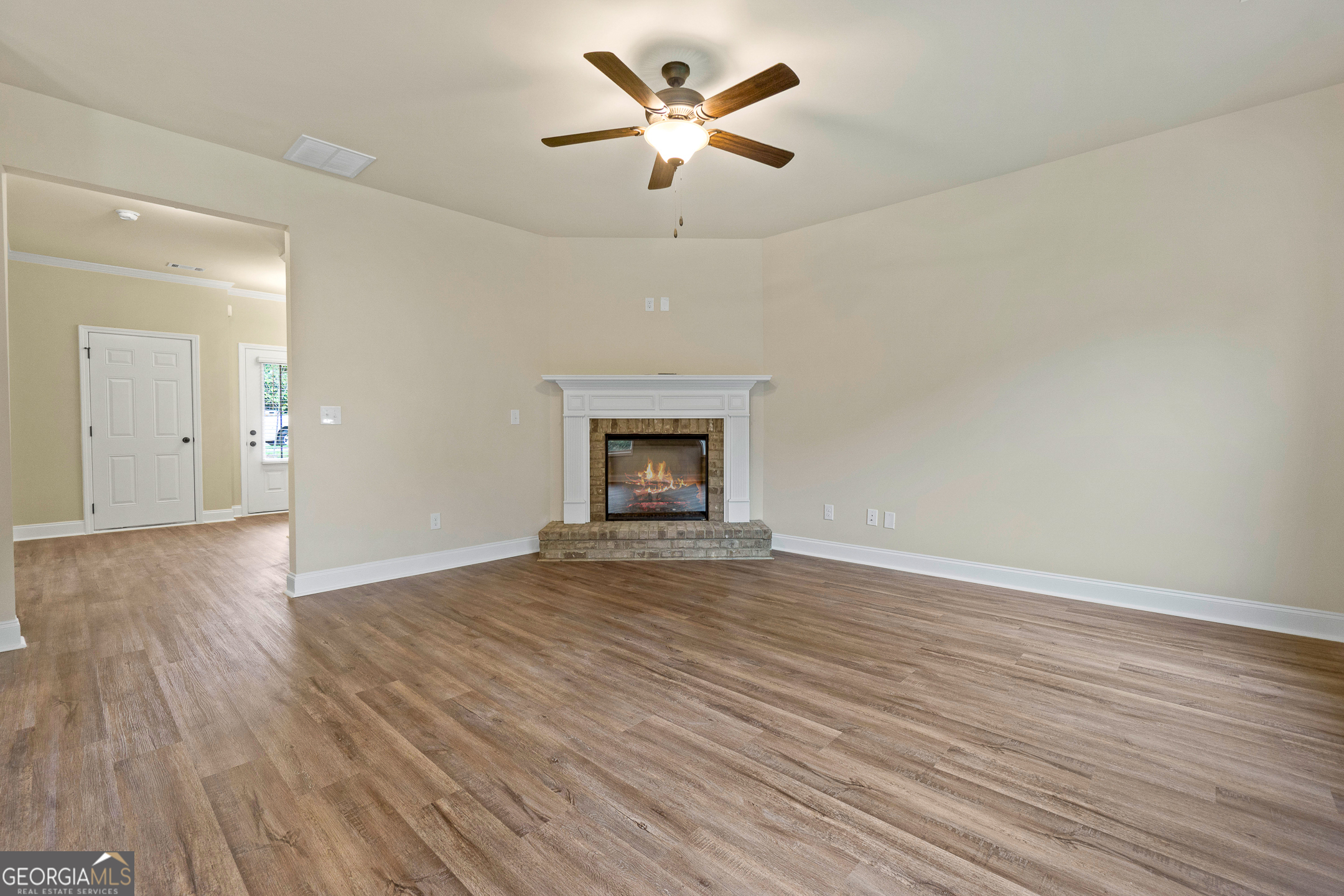 2275 Lovejoy Road Hampton, GA 30228 - Photo 9 of 20 an empty room with wooden floor ceiling fan and window