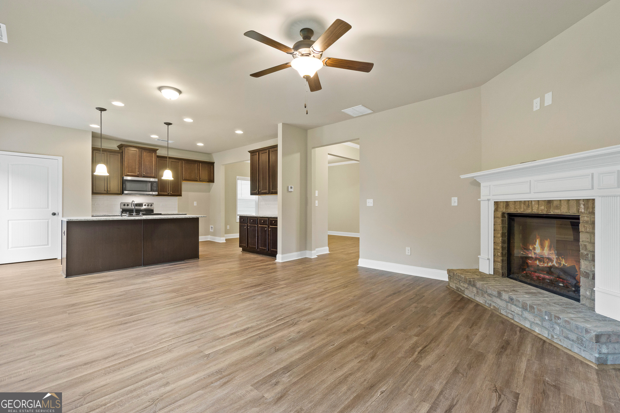 2275 Lovejoy Road Hampton, GA 30228 - Photo 10 of 20 a view of an empty room with kitchen and a fireplace