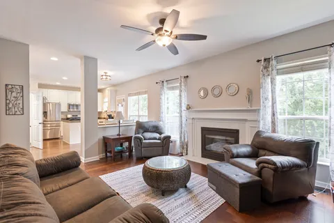 a living room with furniture and a view of kitchen