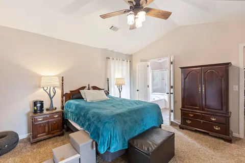 a bed room with a bed and a chandelier