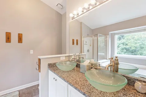 a bathroom with a tub and view of bathroom