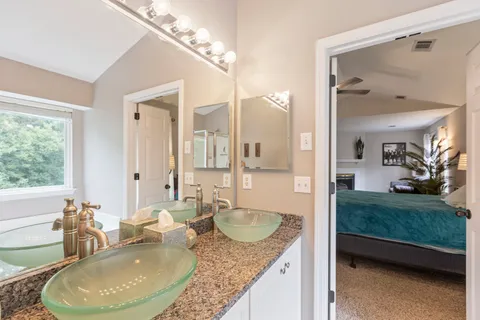 a bathroom with bathtub and window
