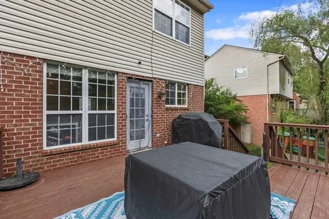 a view of balcony with wooden floor and outdoor seating