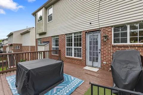 a view of a house with a yard and sitting area