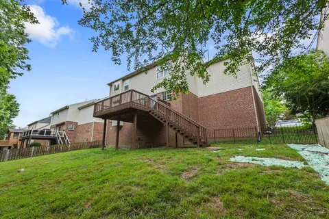 a view of a backyard with a deck and a garden