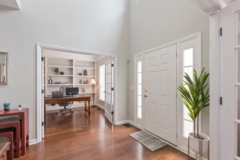 a view of an entryway with wooden floor and a potted plant