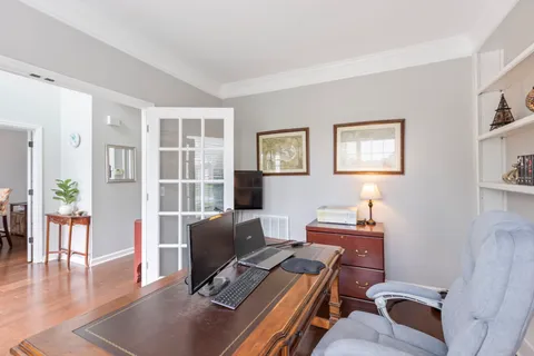a workspace with furniture and wooden floor