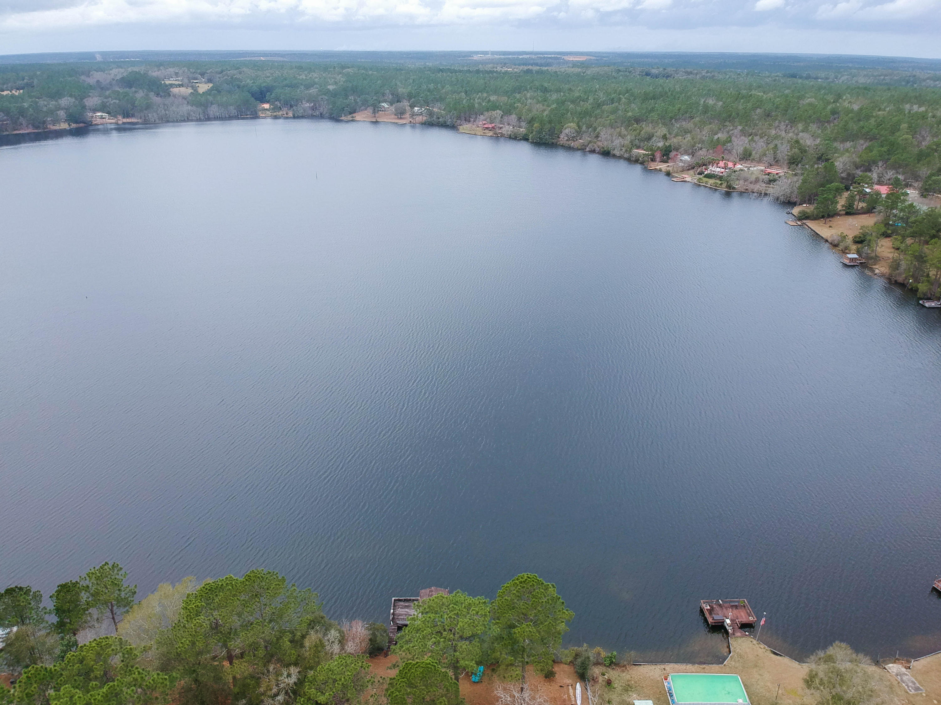 0 Spring Lake Road DeFuniak Springs, FL 32433 - Photo 3 of 16 a view of a lake with a mountain in the background
