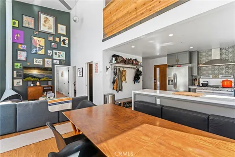 a room with furniture and view of kitchen