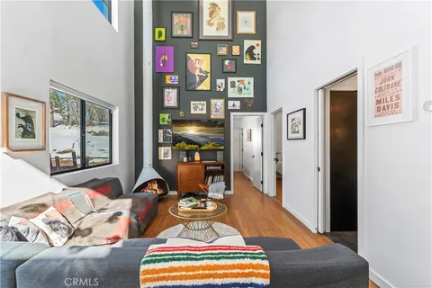 a living room with furniture and floor to ceiling windows