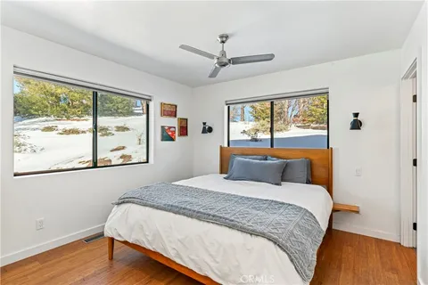 a bedroom with a large bed and a large window