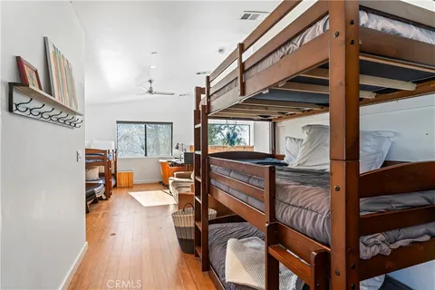 a view of entryway a livingroom and hall with wooden floor