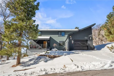 a view of a house with snow in front of it