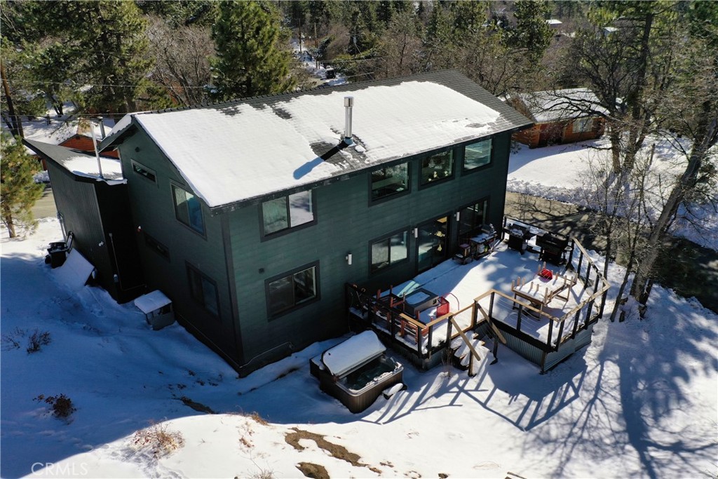 32945 Juniper Lane Green Valley Lake, CA 92341 - Photo 37 of 53 a view of a patio with table and chairs with barbeque grill and wooden fence